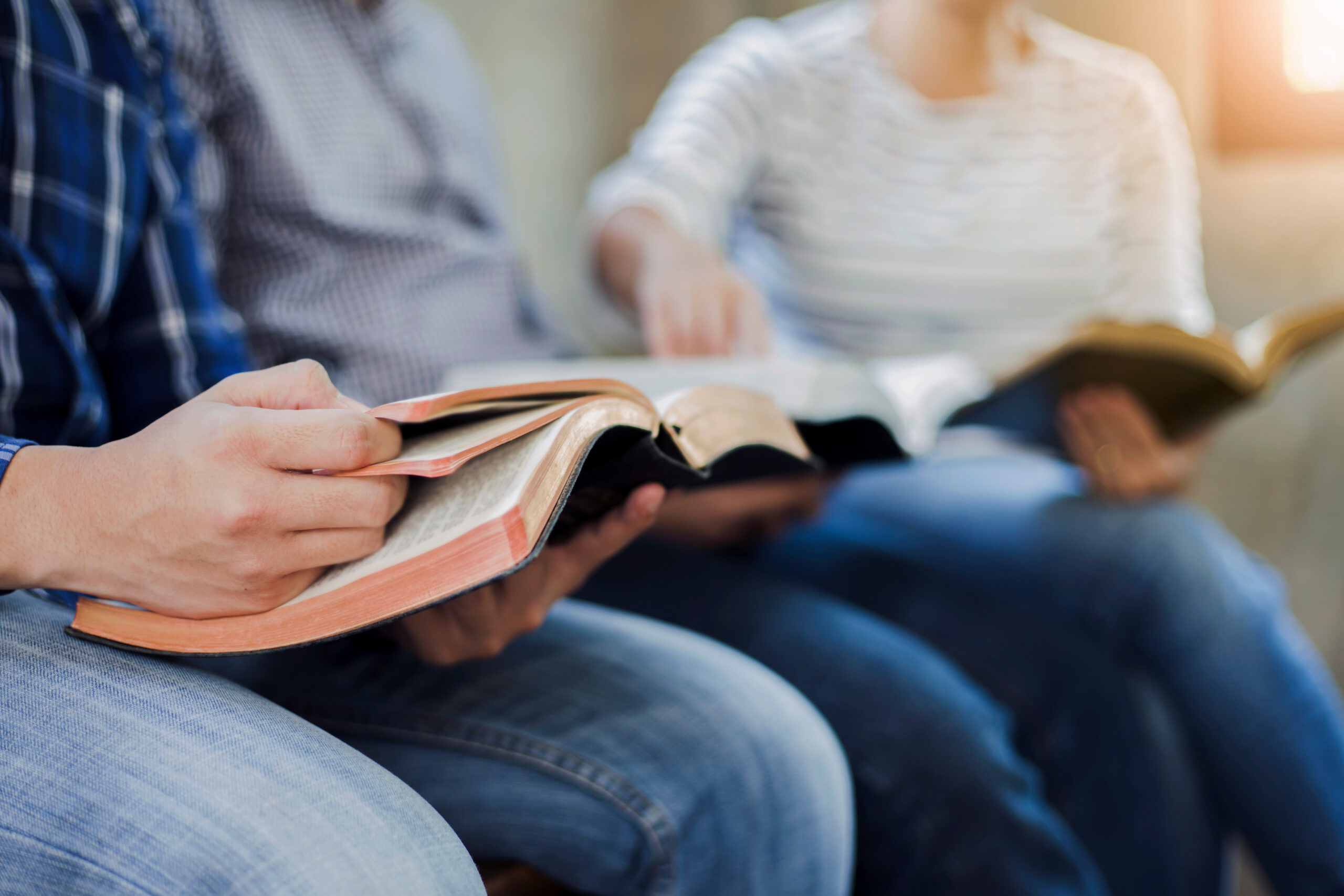 Christian friends group reading and study bible together in home